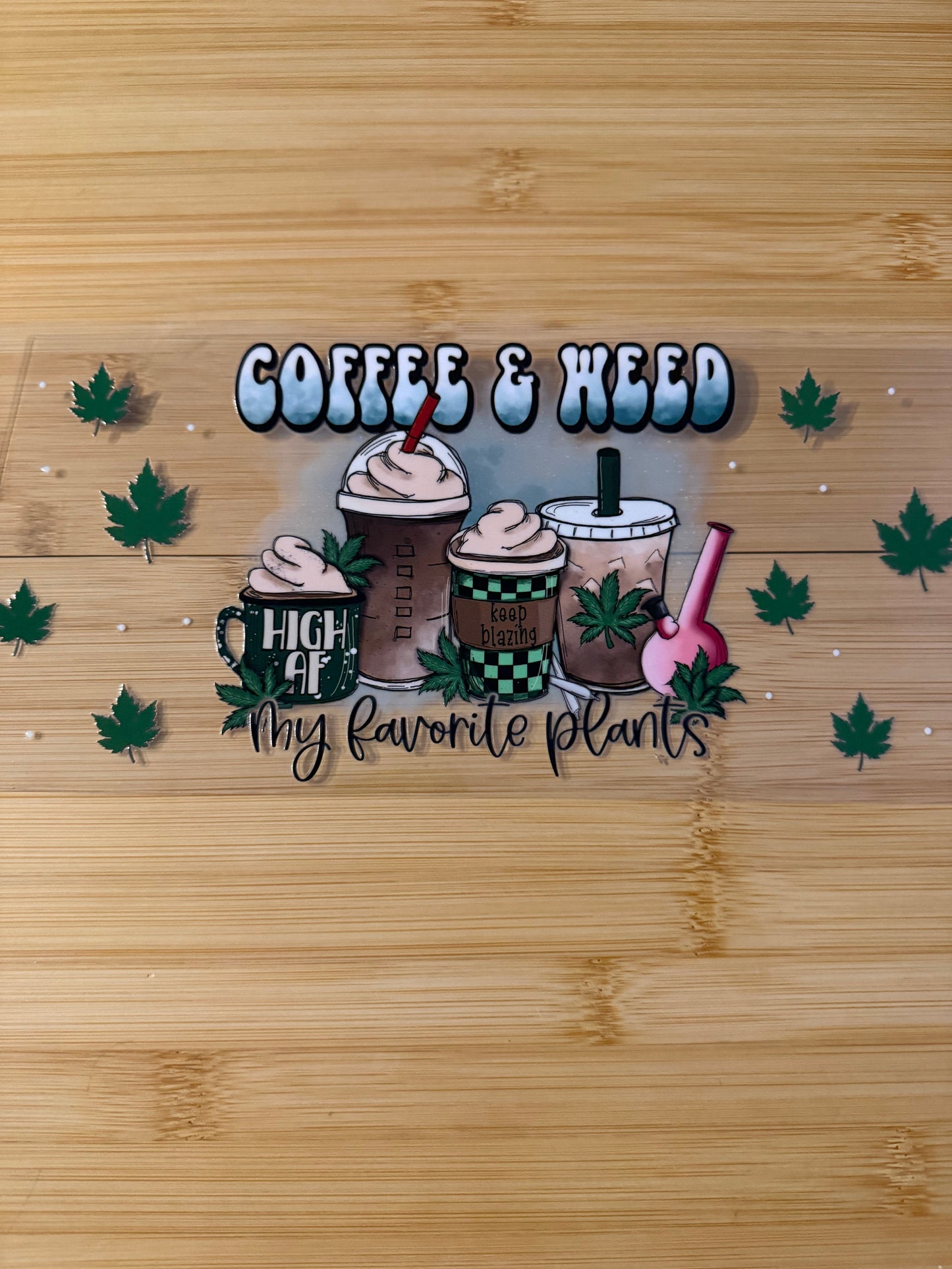 Decorative mat with coffee and weed text on a wooden surface